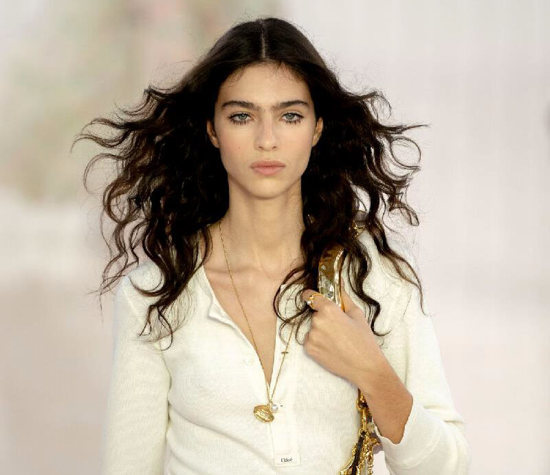 Female model with flowing long hair walking the Chloe runway