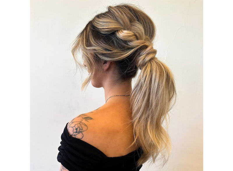 Woman with her hair styled in a braided ponytail
