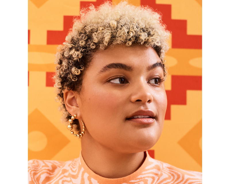 A woman with afro textured blonde hair