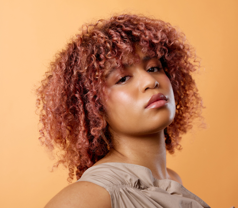 Woman with curly hair modelling evo's new horizon colour