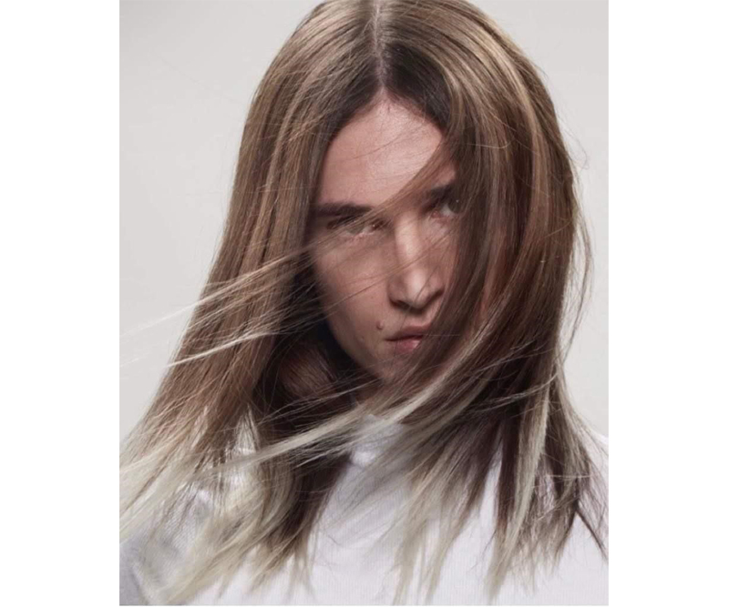 Man with long dark hair and blonde frosted tips