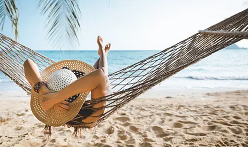 Woman in a hamoc on the beach