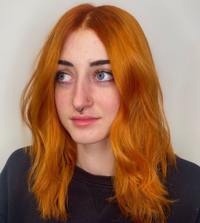A woman with pumpkin spice coloured hair