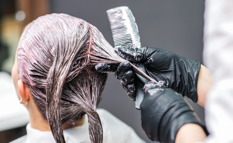 hairdresser removing black dye from hair
