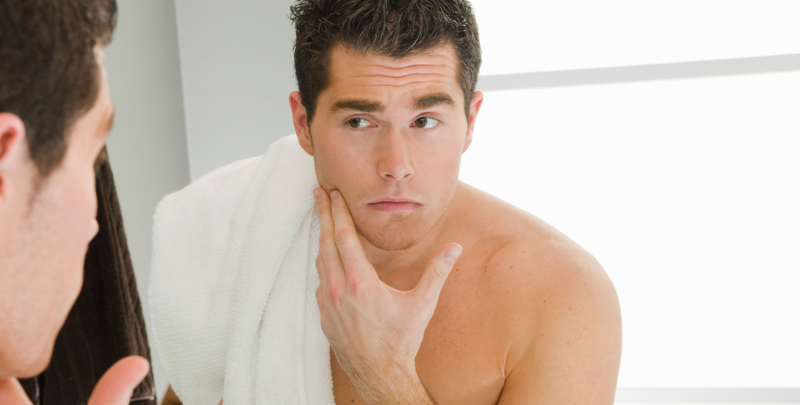 Man looking in the bathroom mirror