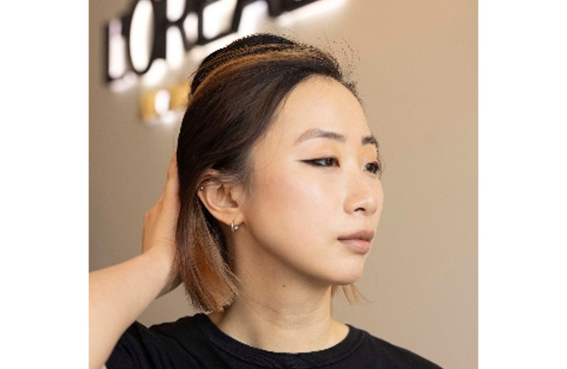 A woman with shoulder length balayage coloured hair