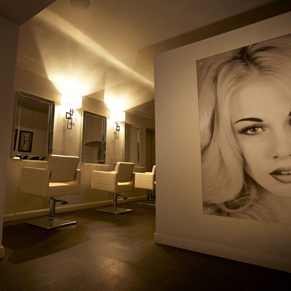 Salon styling stations with a large photos of a blonde model on the side wall