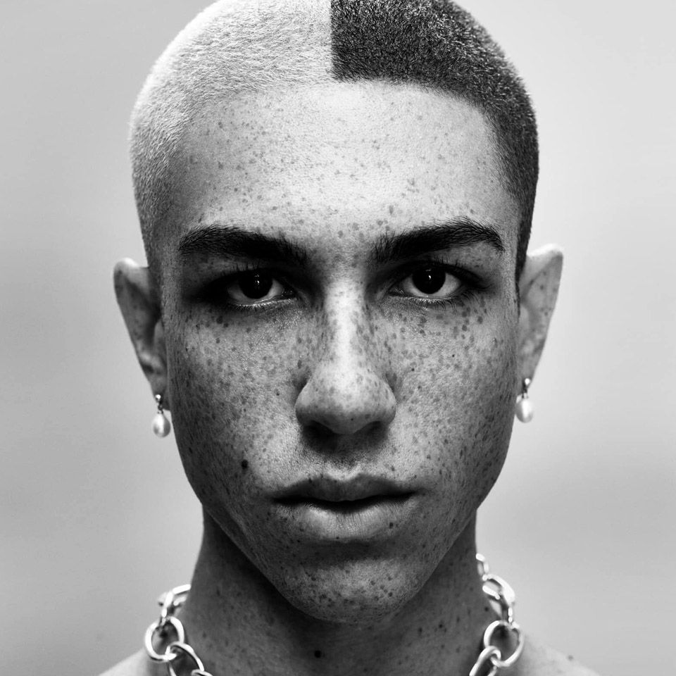 Black and white image of a man with short coloured hair created by Ego Hair Design