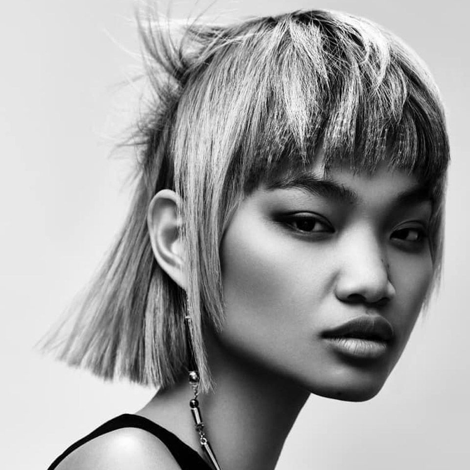 Black and white image of a woman with short blonde hair created by Ego Hair Design