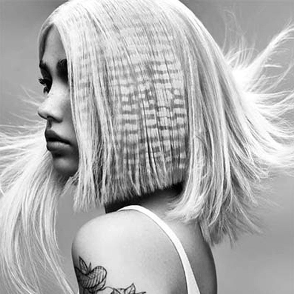 Black and white image of a woman with blonde crimped hair created by Ego Hair Design