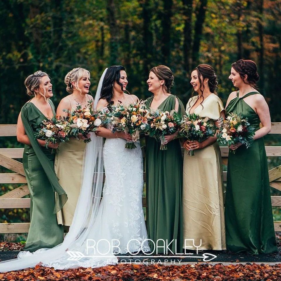 A wedding image with bride and 4 bridesmaids wearing gold and green