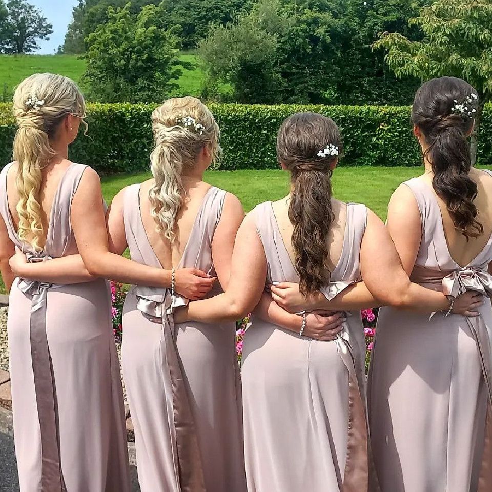 An image of four bridesmaids with ponytails