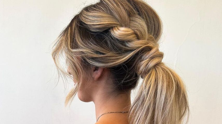 Woman with her hair styled in a braided ponytail