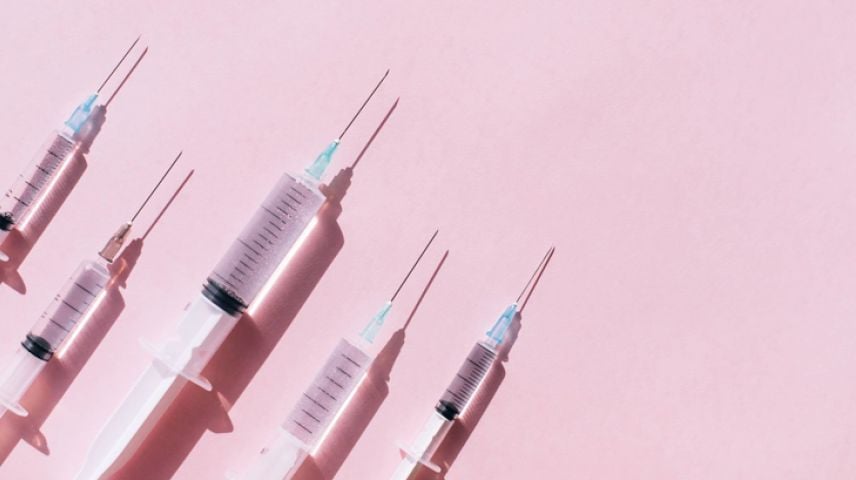 Image of several aesthetic treatment needles on a pink background