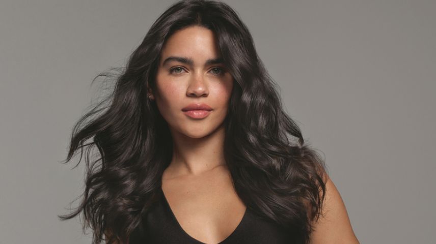Female with long brunette hair styled using Alterna haircare
