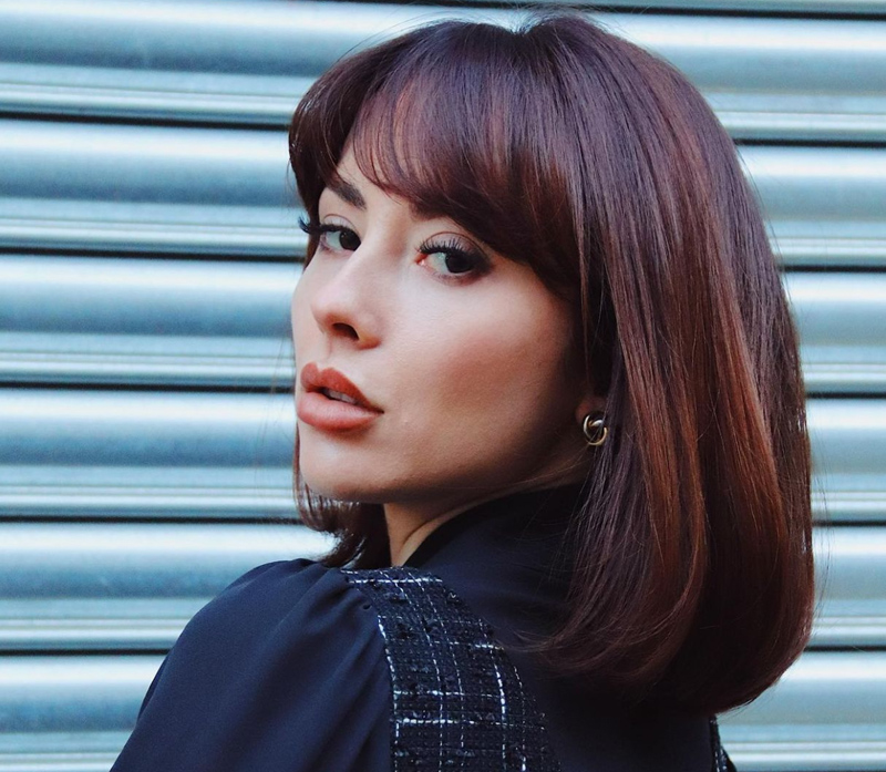 Woman with dark bobbed hair coloured by evo hair colour